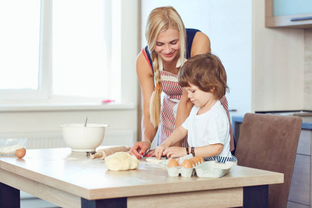 istock Mother and son bake cakes in the kitchen 962866966