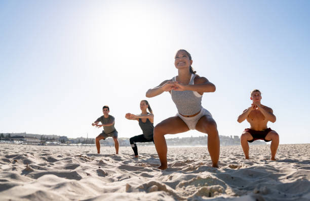 istock Group of people exercising at the beach 962867058