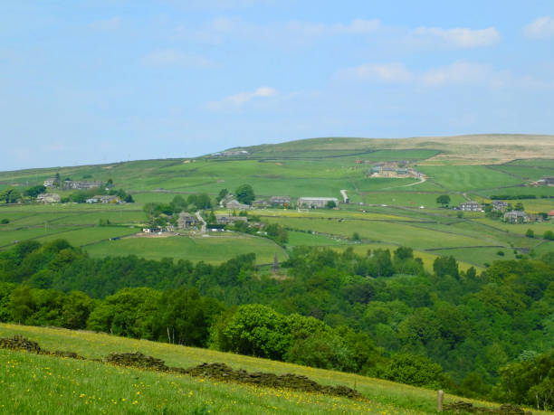 istock west yorkshire dales scenery with farmhouses perched on high hills with typical walled fields and midgley moor in the distance with blue sunlit summer sky with farmhouses in the pecket well area 962873722