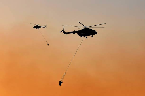 istock fire-fighting helicopters. fire in the city 962887326