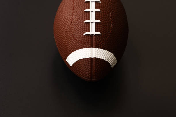 istock American football isolated on black background . Sport object concept 962888198