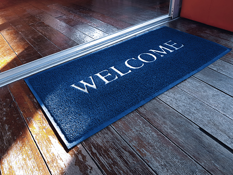 Doormat with Welcome Text in Front of Shop