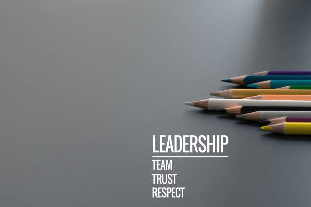 leadership business concept. gold color pencil lead other color with word leadership, team, trust and respect on black background - in gold we trust imagens e fotografias de stock