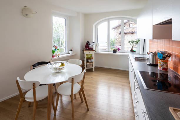 istock Kitchen with orange tiles and a modern table. Large window with a view 962898568