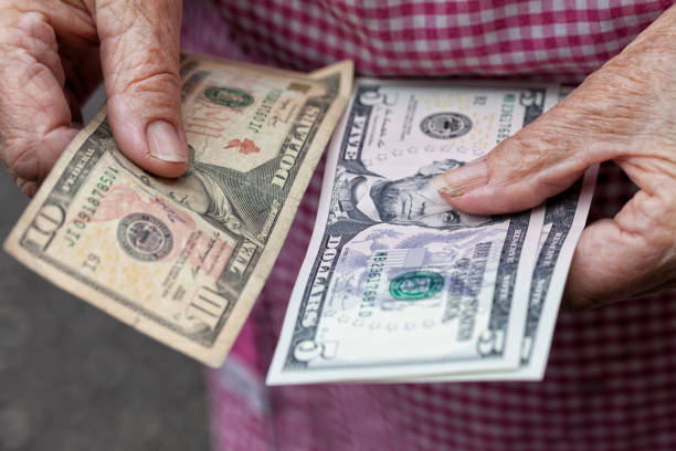 istock An elderly lady holds 20 dollars in her hands 962899348