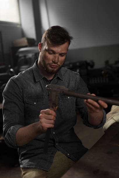 istock young workman measuring metal part at factory 962899858