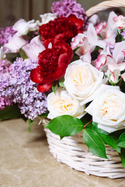istock Bouquet of lilacs and red peonies on marble table 962903802