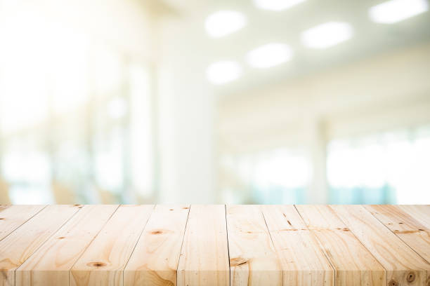 istock Wooden table with blur background of office room. 962904394