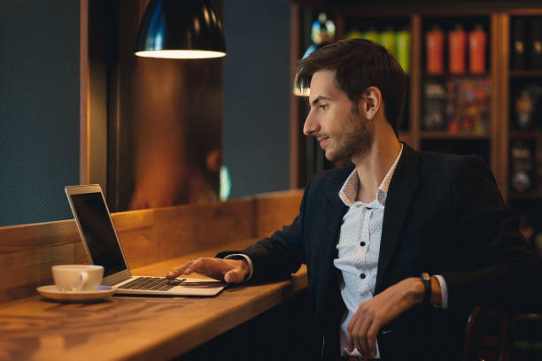 istock Portrait young confident businessman looking to laptop screen 962910886