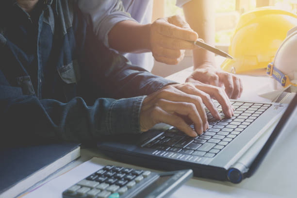 istock Architect engineer working concept with laptop and construction tools or safety equipment on table. 962911252