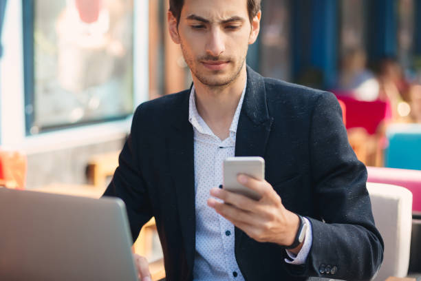 istock Man looking to phone and touching the screen 962911506