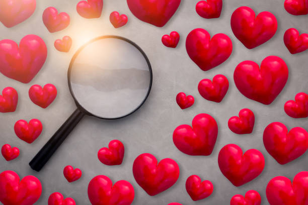 istock magnyfy glass with red heart object shape on grey leather background with free copyspace for your creativity ideas text 962911632