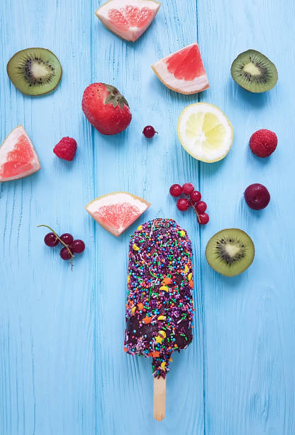 chocolate ice cream, fruit, berries on blue wooden