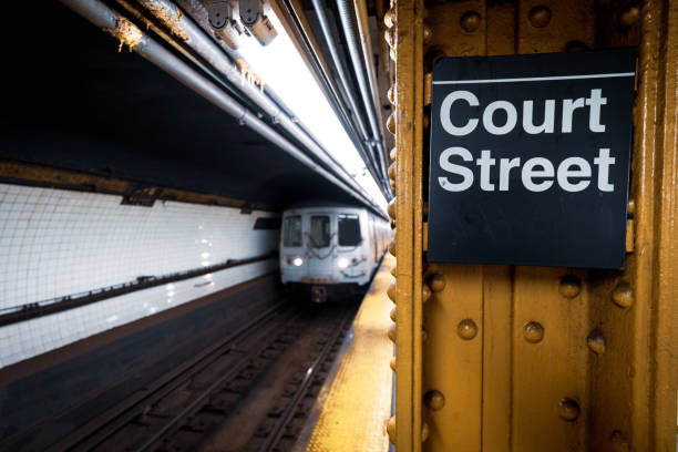 Court Street subway station, in disrepair, as a train approaches