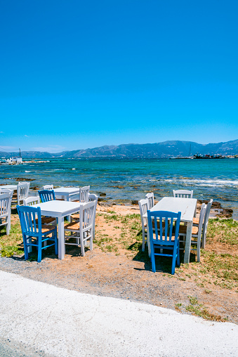 Blue and white chairs with tables in typical Greek tavern, Elafonisos