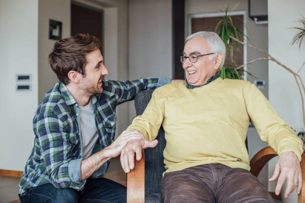 istock Father and son laughing at home 962929160