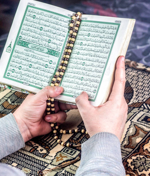 istock a muslim holding Holly Quran with prayer beads 962930868