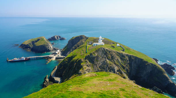 Tourists land from MS Oldenburg on Lundy Island in Devon LUNDY ISLAND, DEVON, UK - MAY 7, 2018: Tourists arrive on MS Oldenburg on Lundy Island from Ilfracombe devon photos stock pictures, royalty-free photos & images