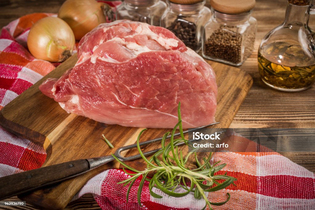 Raw pork shoulder. Raw pork shoulder on cutting board with knife. Pork Stock Photo