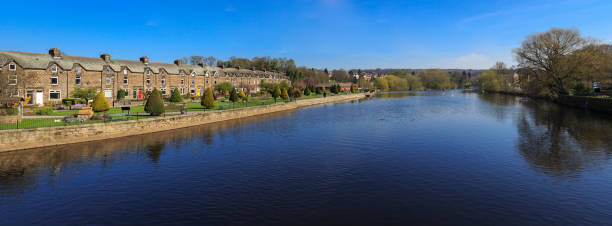 Row of terraced houses by the River Wharfe in Otley near Leeds Row of terraced houses in Otley near Leeds. Otley is a small market town to the north of Leeds. river wharfe stock pictures, royalty-free photos & images