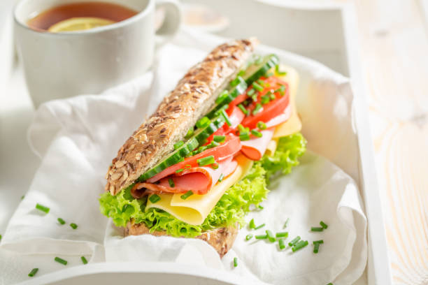 istock Fresh sandwich with cheese, ham and cucumber for breakfast 962944416