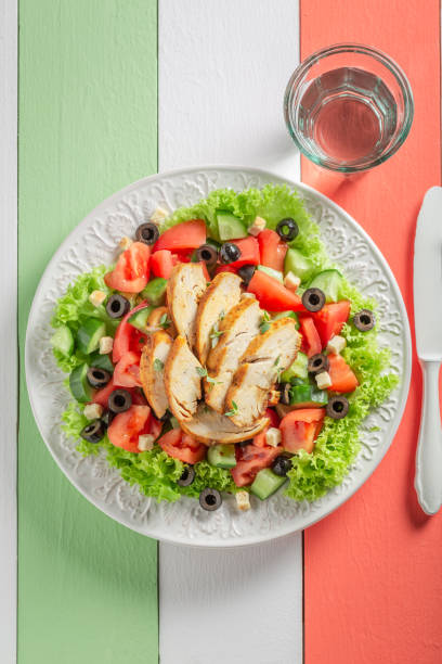 istock Tasty Caesar salad with tomatoes, cucumber and chicken 962944696