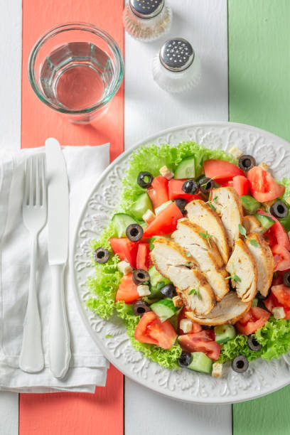 istock Healthy Caesar salad with tomatoes, cucumber and chicken 962944736