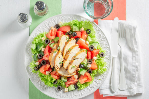 istock Healthy Caesar salad with chicken, olives and tomatoes 962944780