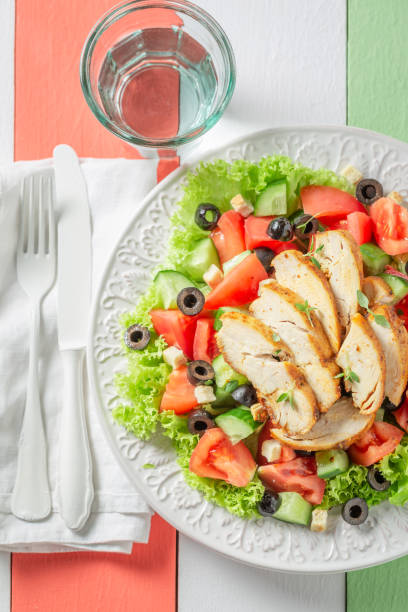 istock Tasty Caesar salad with olives, tomatoes and lettuce 962944804