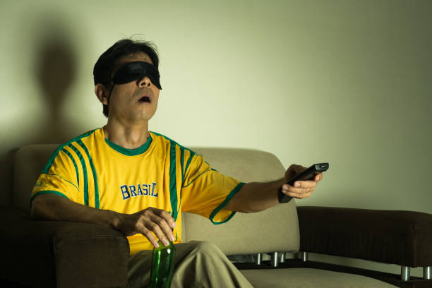 brazilian-male-fan-supporter-watches-sports-on-tv-with-an-eye-mask-zapping.jpg