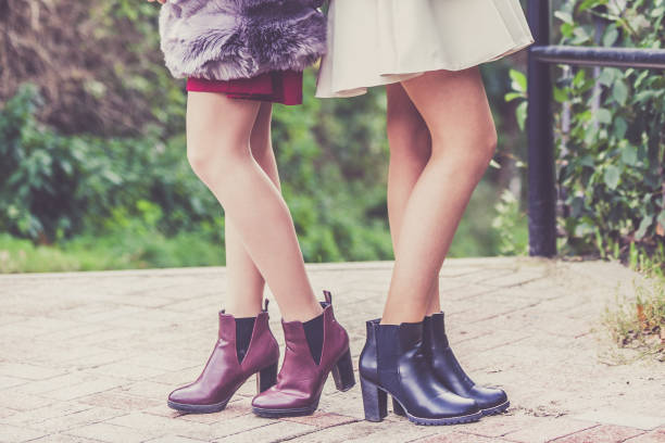 istock Two women presenting shoes outdoor 962948806