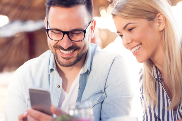 istock Smiling couple in coffee shop 962951860