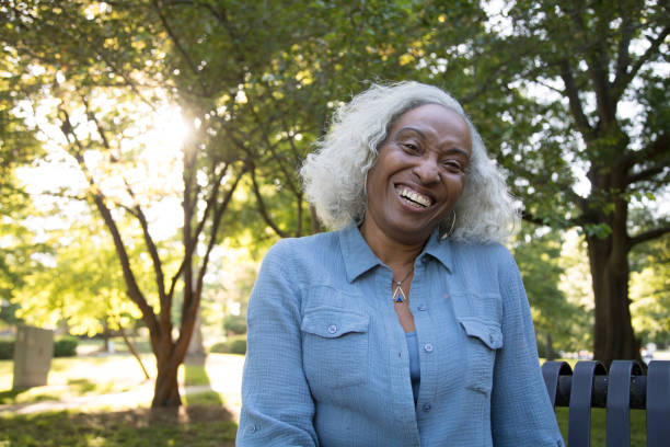 istock Senior Woman Outside on a Bench Laughing 962952576