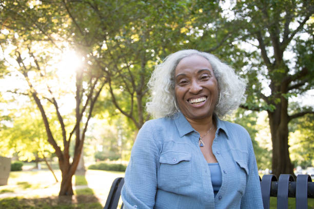 istock Senior Woman Outside on a Bench Laughing 962952656