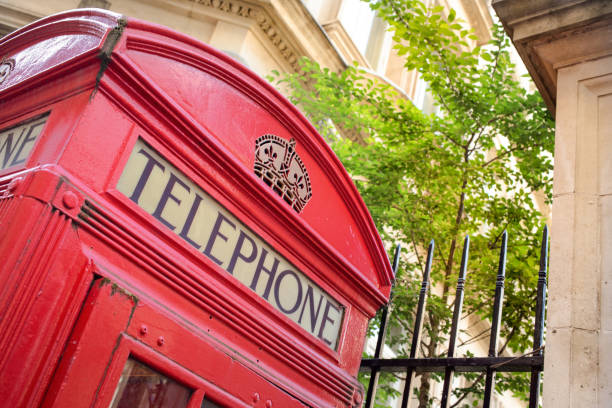 istock old style red telephone box in a leafy London square, England 962953246