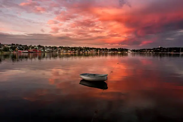 Sunset on the beautiful town of Lunenburg Nova Scotia showcasing a boat in the harbor