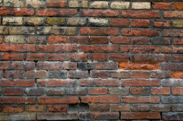 istock Dirty red vintage brick wall with shabby structure 962953630