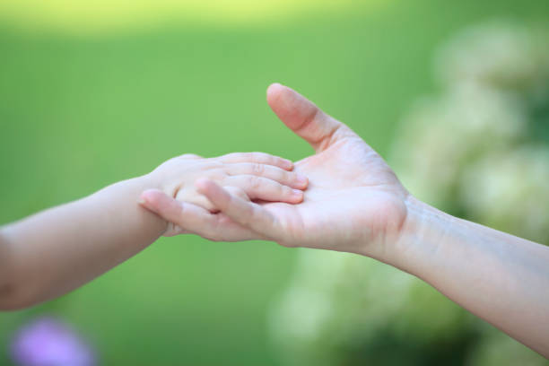 istock Mother And Baby Holding Hands 962953866