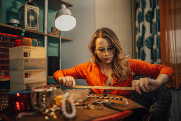 istock Young crafty woman making jewelry in the workshop 962954716