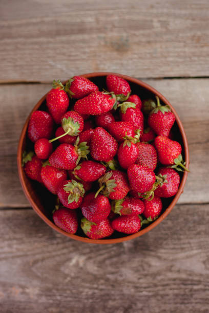 istock Strawberry in a bowl on a wooden table 962963478