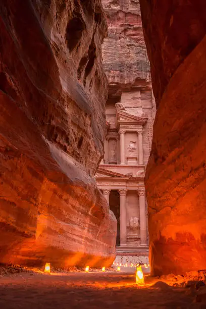 Petra by night, Jordan. The symbol of Petra, the Treasury and the Siq canyon illuminated by candle lights