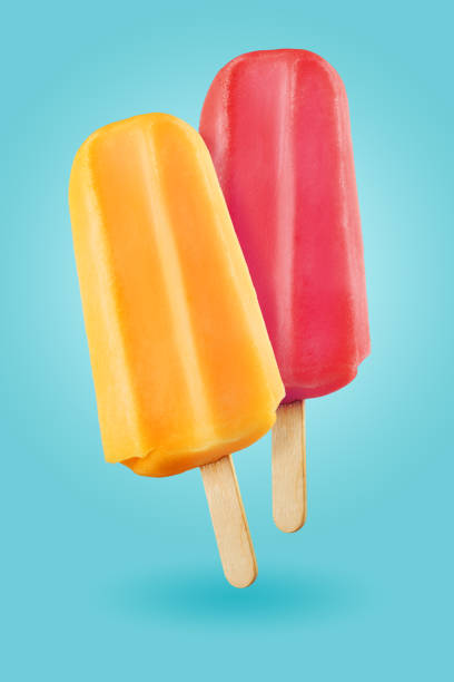 Popsicles on blue background Yellow and purple popsicles ice cream sticks on the blue background flavored ice photos stock pictures, royalty-free photos & images