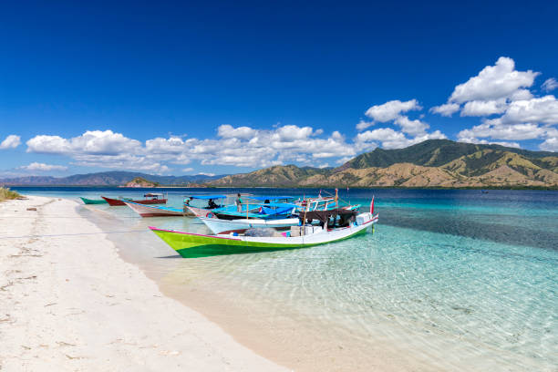 Beautiful clear water and fishing boats in the Seventeen Island National Park, Indonesia.