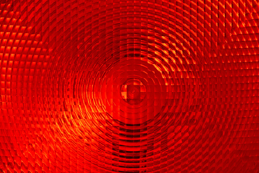 Abstract background of red faceted plastic reflective surface sign or rear lamp of taillight