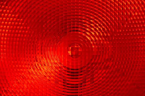 Abstract background of red faceted plastic reflective surface sign or rear lamp of taillight