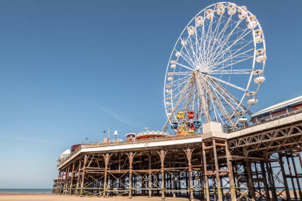 Ferris wheel on the pier at Blackpool, Lancashire\n+ signs and logos removed. People in distance too small to be recognisable