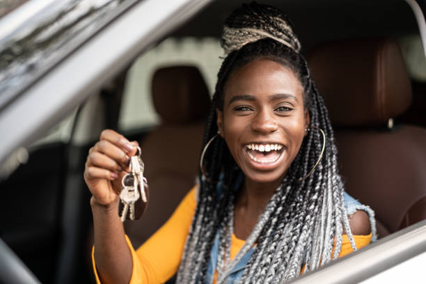 Young woman is excited about new car Woman Sitting In Car With Key car key photos stock pictures, royalty-free photos & images