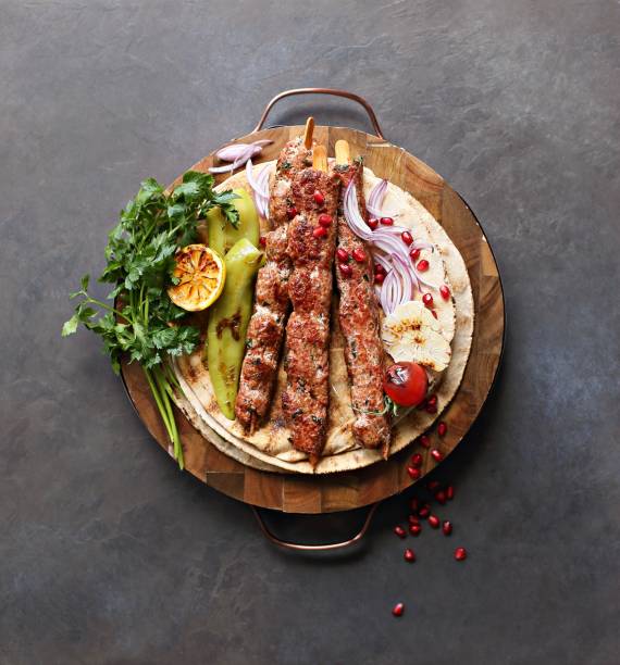 Kebab. Kebab. Traditional middle eastern, arabic or mediterranean  meat kebab with vegetables and herbs. Overhead view, copy space persian culture stock pictures, royalty-free photos & images