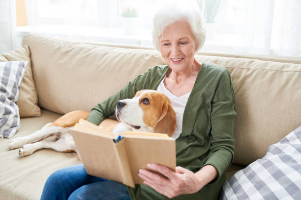istock Senior Woman Relaxing at Home with Pet 962984124