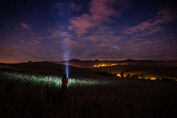 istock Young happy woman at starry night in mountains. 962995370